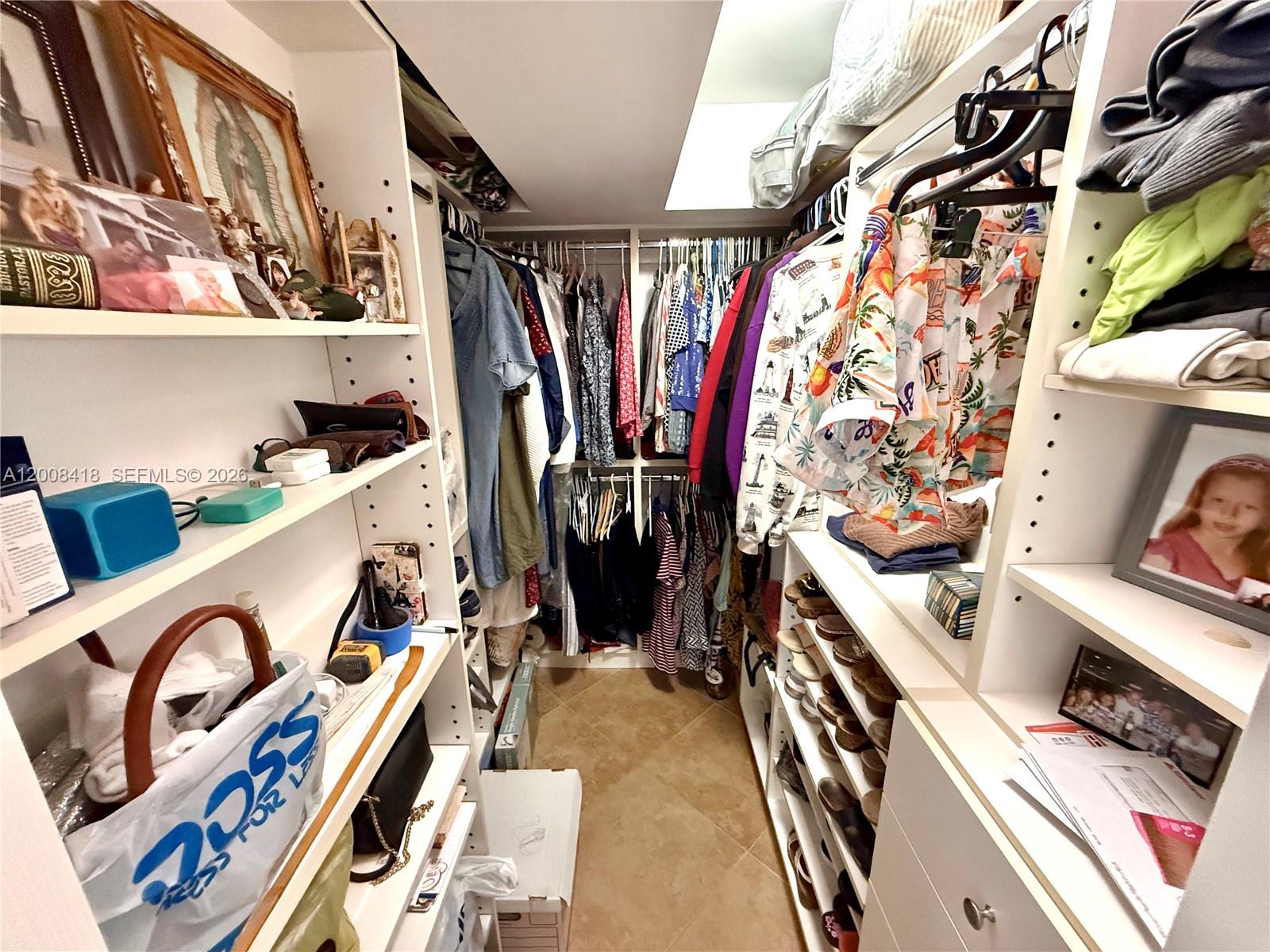 10440 Southwest 156th Court, Unit 712 Miami, FL 33196 - Photo 6 of 10 a view of walk in closet with clothes and shoes