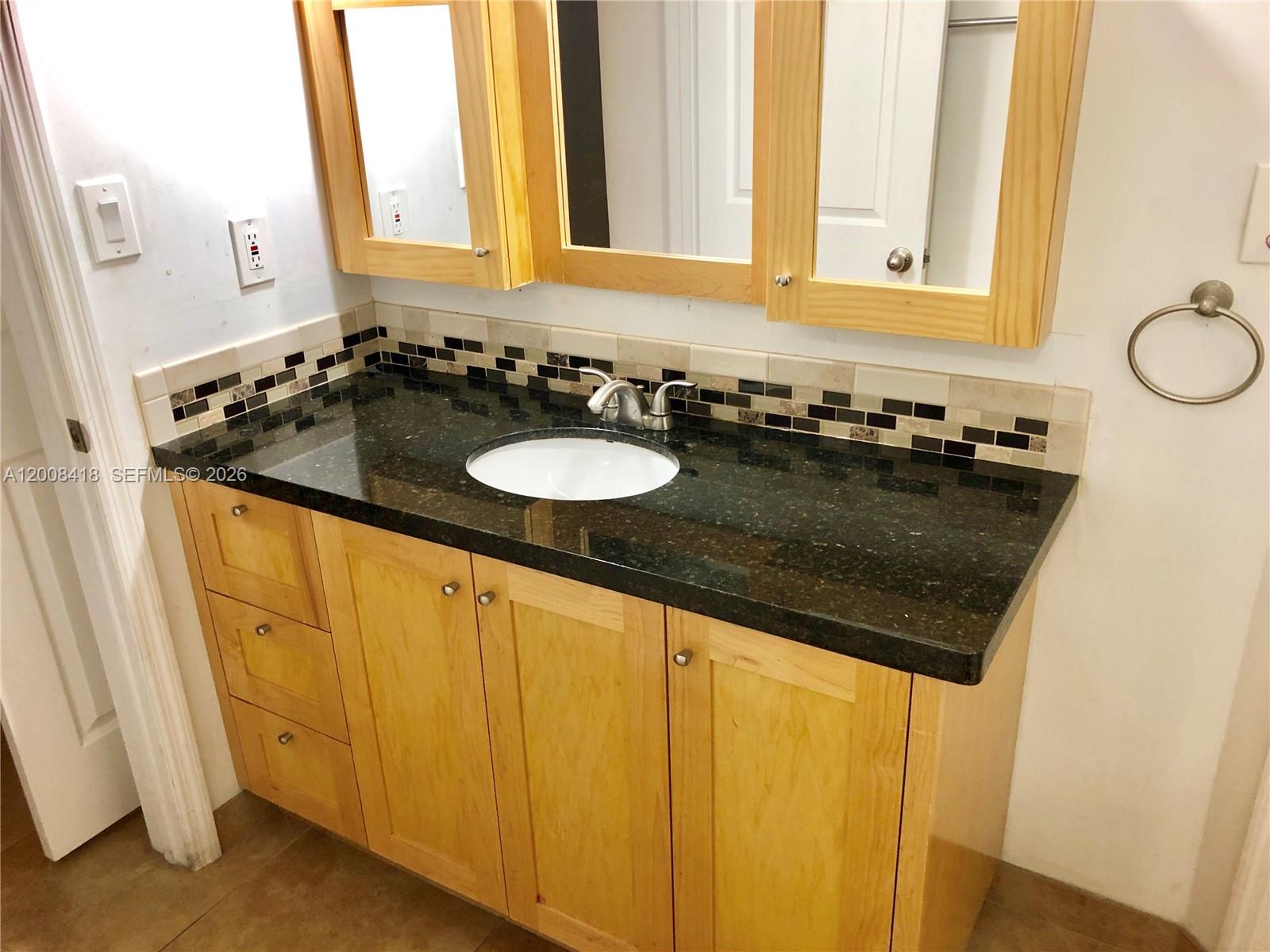 10440 Southwest 156th Court, Unit 712 Miami, FL 33196 - Photo 8 of 10 a bathroom with a sink and a mirror
