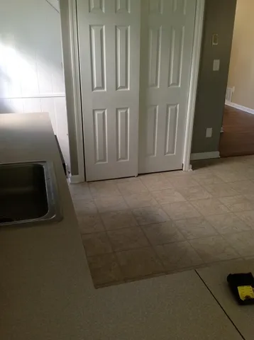 a view of a room with wooden floor
