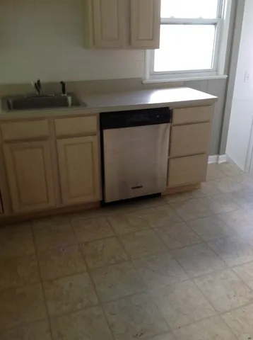 a kitchen with a sink and cabinets