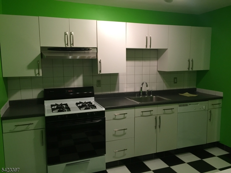 1130 Valley Road, Unit 2B Wayne, NJ 07470 - Photo 15 of 18 a kitchen with a sink a stove and cabinets