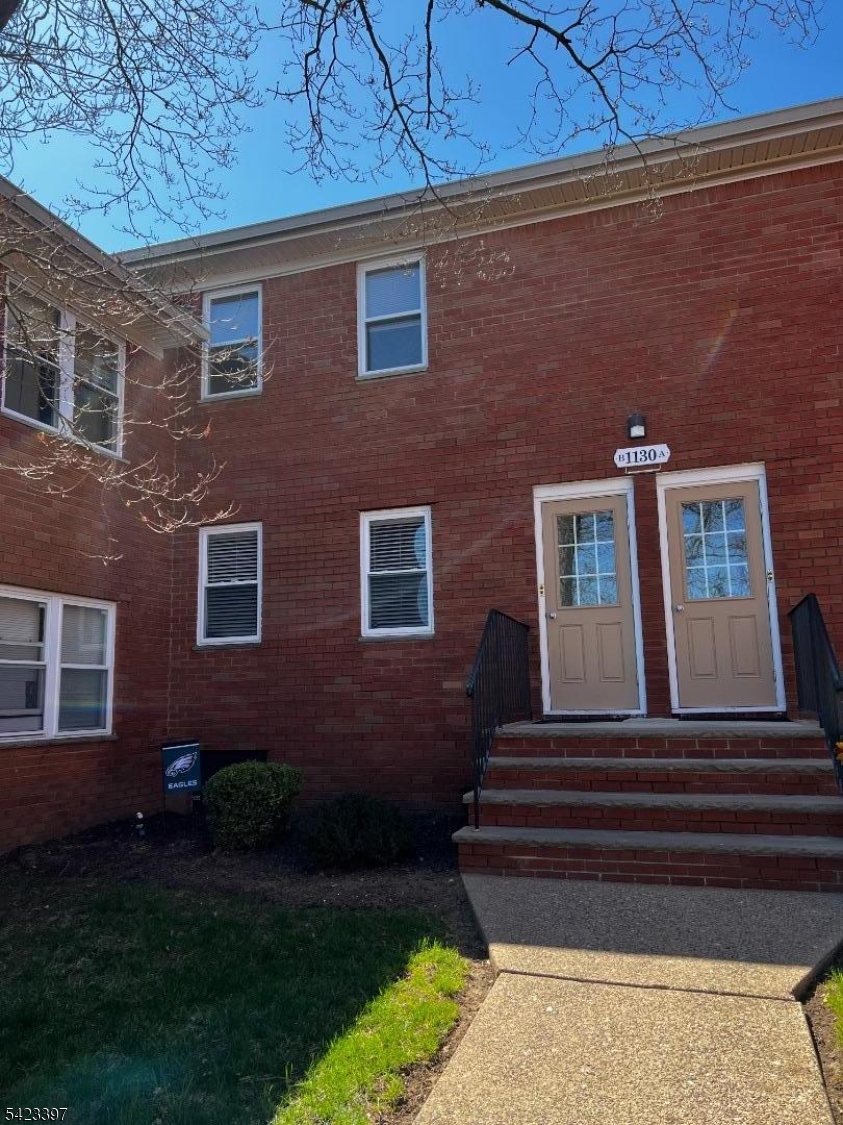 1130 Valley Road, Unit 2B Wayne, NJ 07470 - Photo 2 of 18 a front view of a house with a garden