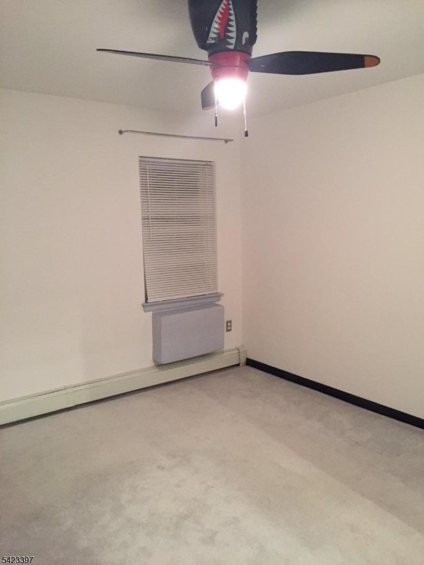 1130 Valley Road, Unit 2B Wayne, NJ 07470 - Photo 7 of 18 a view of an empty room with a chandelier fan