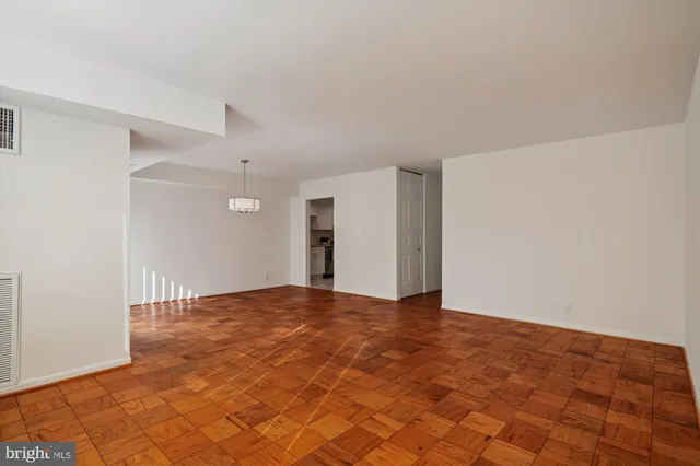a dining room with furniture a chandelier and wooden floor