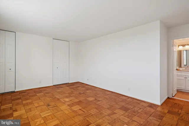 a view of a room with a white wall and a window