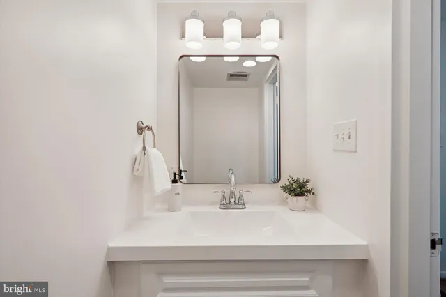 a view of a building with potted plants and a bench
