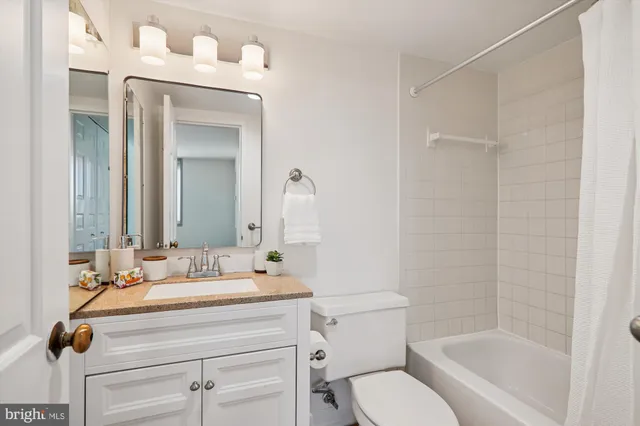 a view of a building with potted plants and a bench