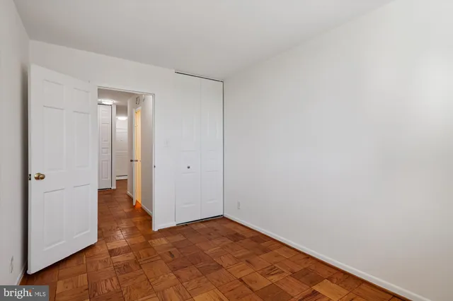 a living room with furniture a table and kitchen view