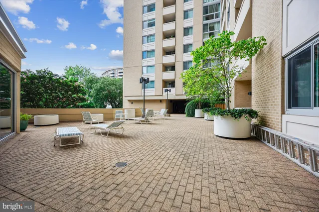 a view of a hallway with wooden floor and a bathroom