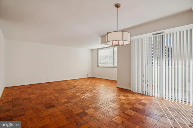 a living room with furniture a table and a potted plant