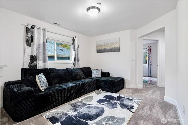 a living room with furniture and a rug