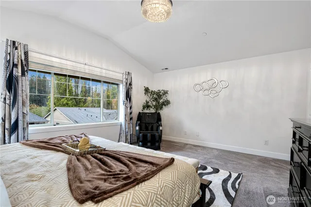 a bed sitting in a bedroom next to a window