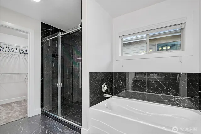 a bathroom with a bathtub and a shower