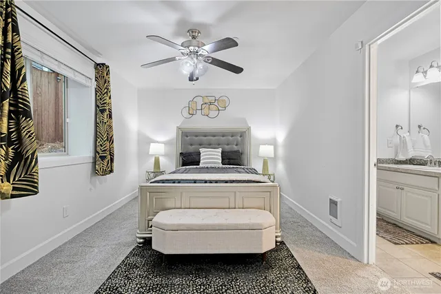a bedroom with a bed and ceiling fan