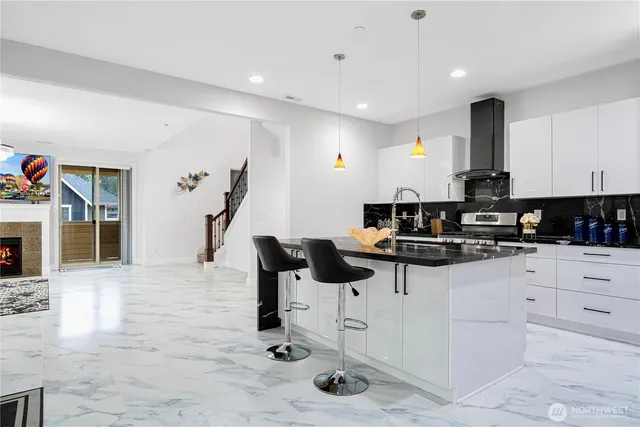 a kitchen with stainless steel appliances kitchen island granite countertop a sink and cabinets