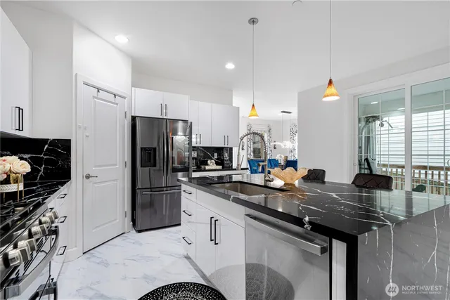 a kitchen with a sink a stove and refrigerator