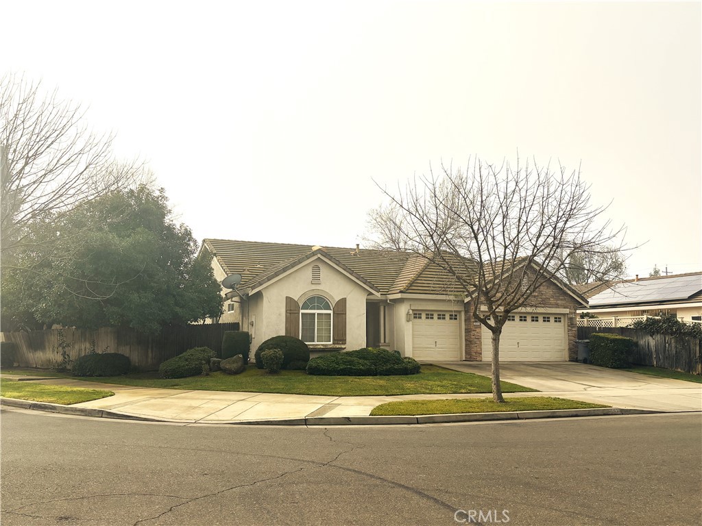 3533 San Isidro Avenue Merced, CA 95348 - Photo 1 of 3 a view of white house with a road and large trees