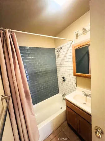 a bathroom with a sink a bathtub and a shower