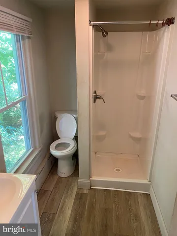 a bathroom with a toilet and a shower