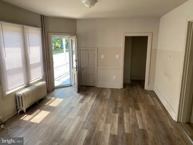 a view of a room with wooden floor and doors