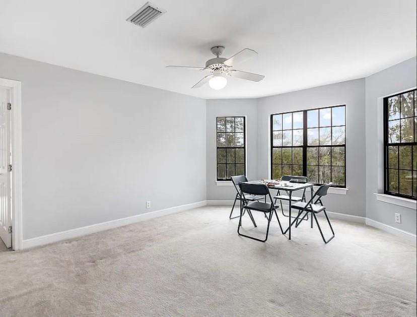 1525 Black Island Road Darien, GA 31305 - Photo 15 of 41 a dining room with furniture and a chandelier