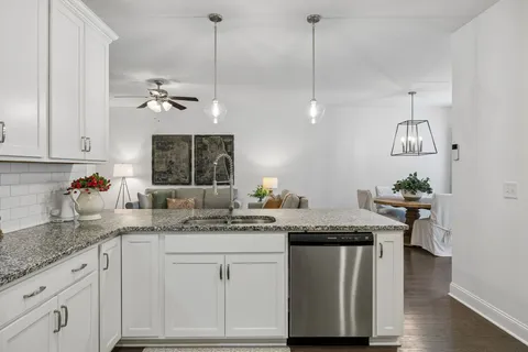 a bathroom with a granite countertop sink a mirror and vanity