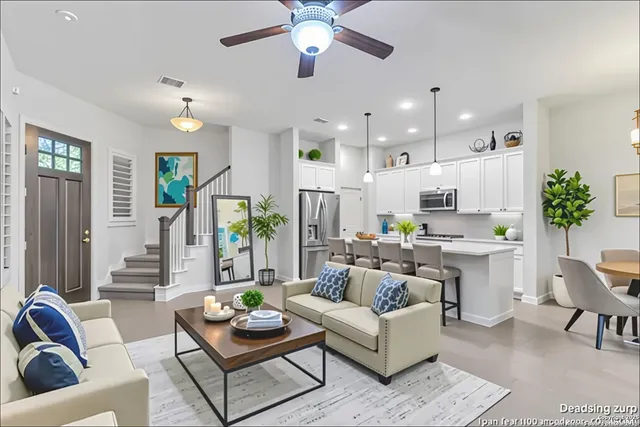 a living room with furniture kitchen and a chandelier