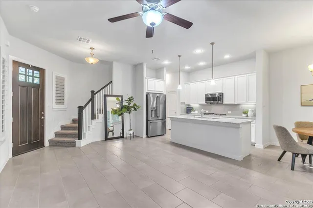 a view of a kitchen with appliances and furniture