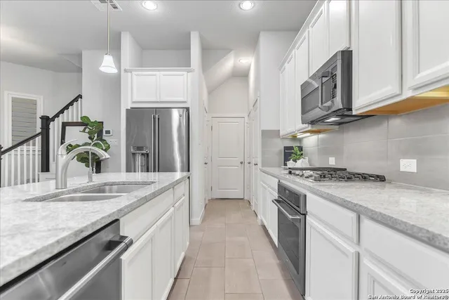 a kitchen with stainless steel appliances granite countertop a stove and a sink