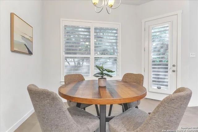 a view of a dining room with furniture and window