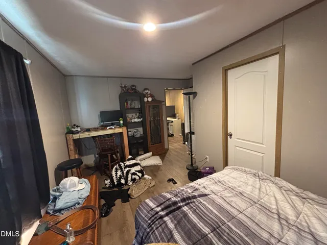 a bedroom with a bed and a desk