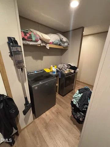 a living room with furniture a flat screen tv and a window