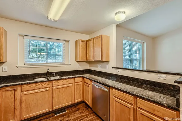 a kitchen with granite countertop a sink and a window