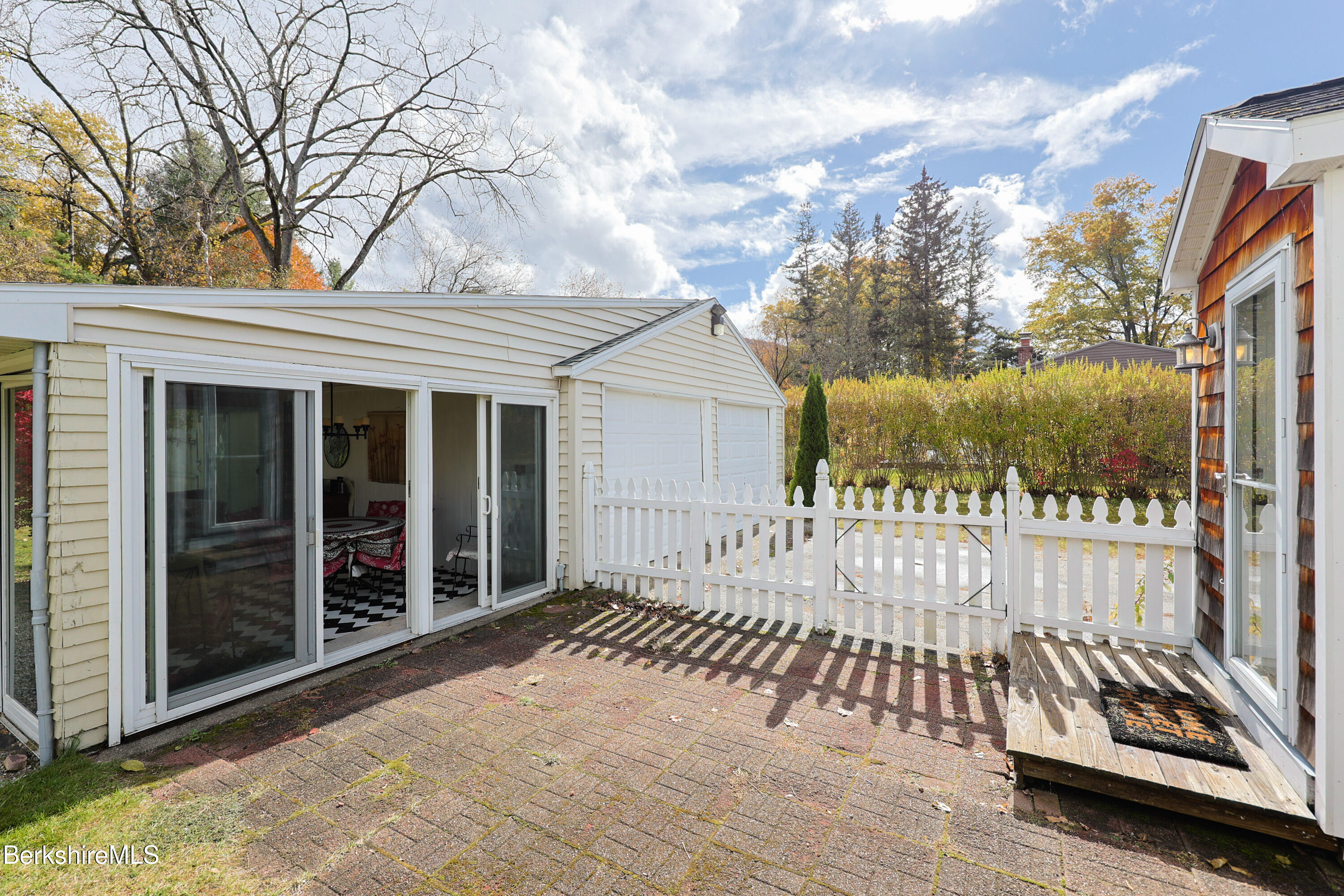 16 East New Lenox Road Lenox, MA 01240 - Photo 3 of 31 a view of a brick house with a large window and wooden fence