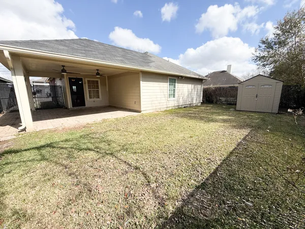 a view of a house with a backyard and a garage