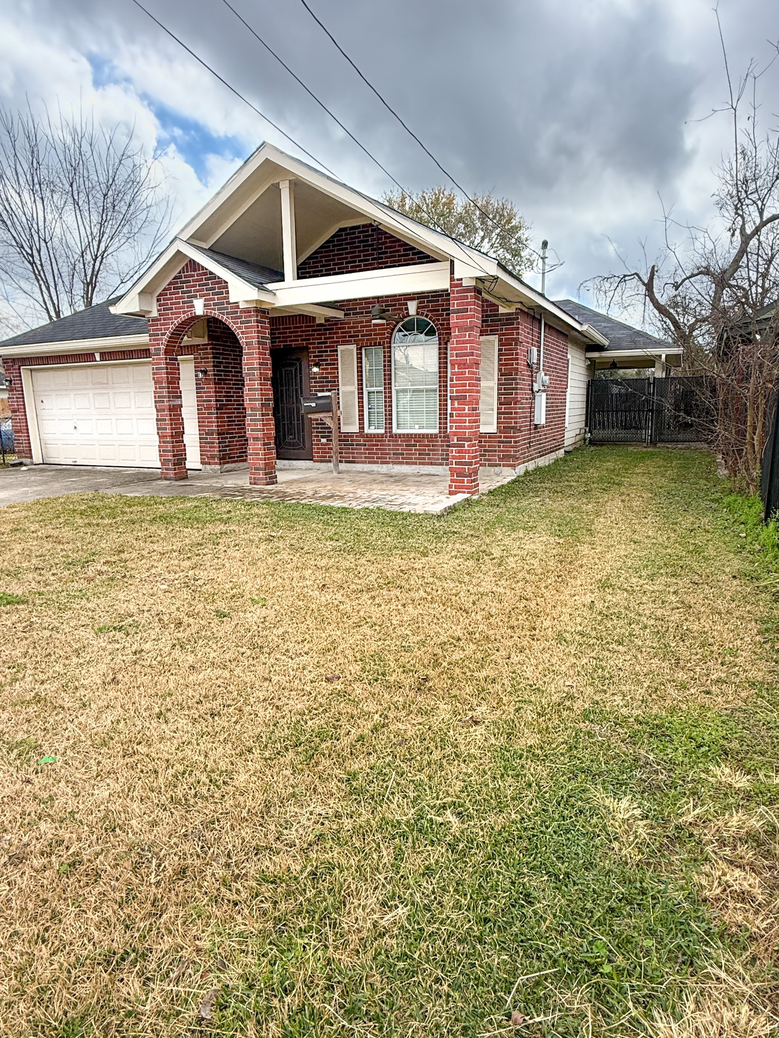 3348 Reeves Street Houston, TX 77004 - Photo 2 of 14 a front view of a house with a yard