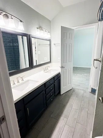 a bathroom with a double vanity sink a and mirror