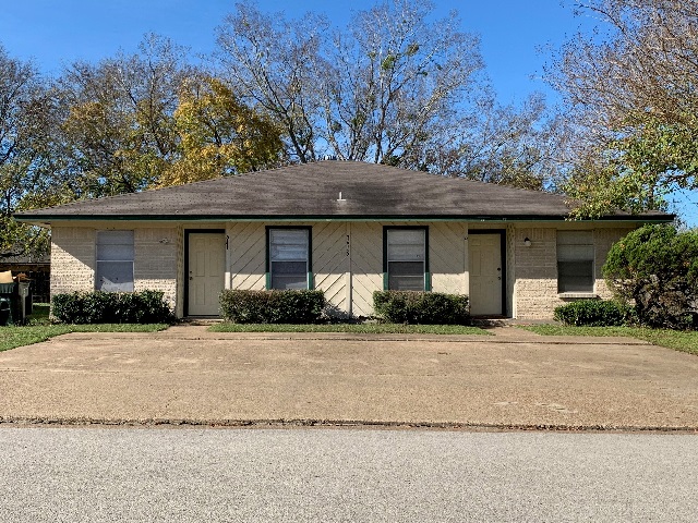3615 Mahan Street, Unit A Bryan, TX 77802 - Photo 1 of 1 a front view of a house with a yard and trees