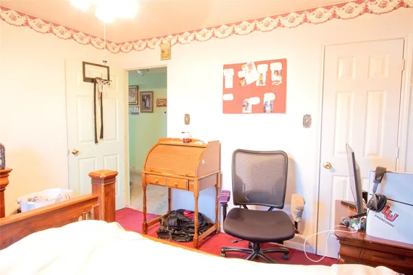 a bedroom with furniture and a mirror