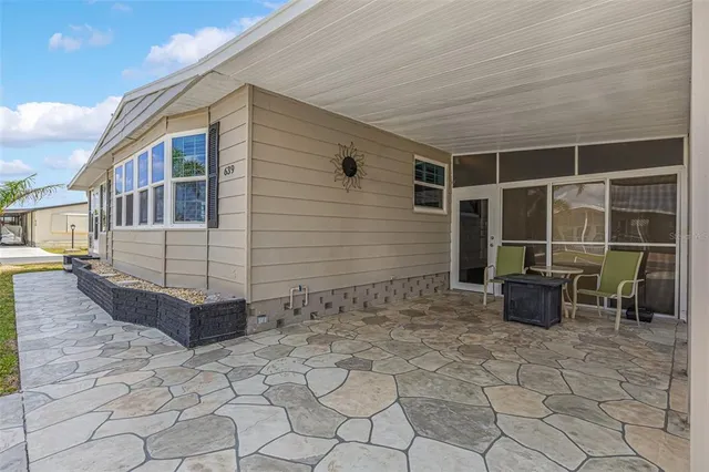 a living room with furniture a fireplace and a large window