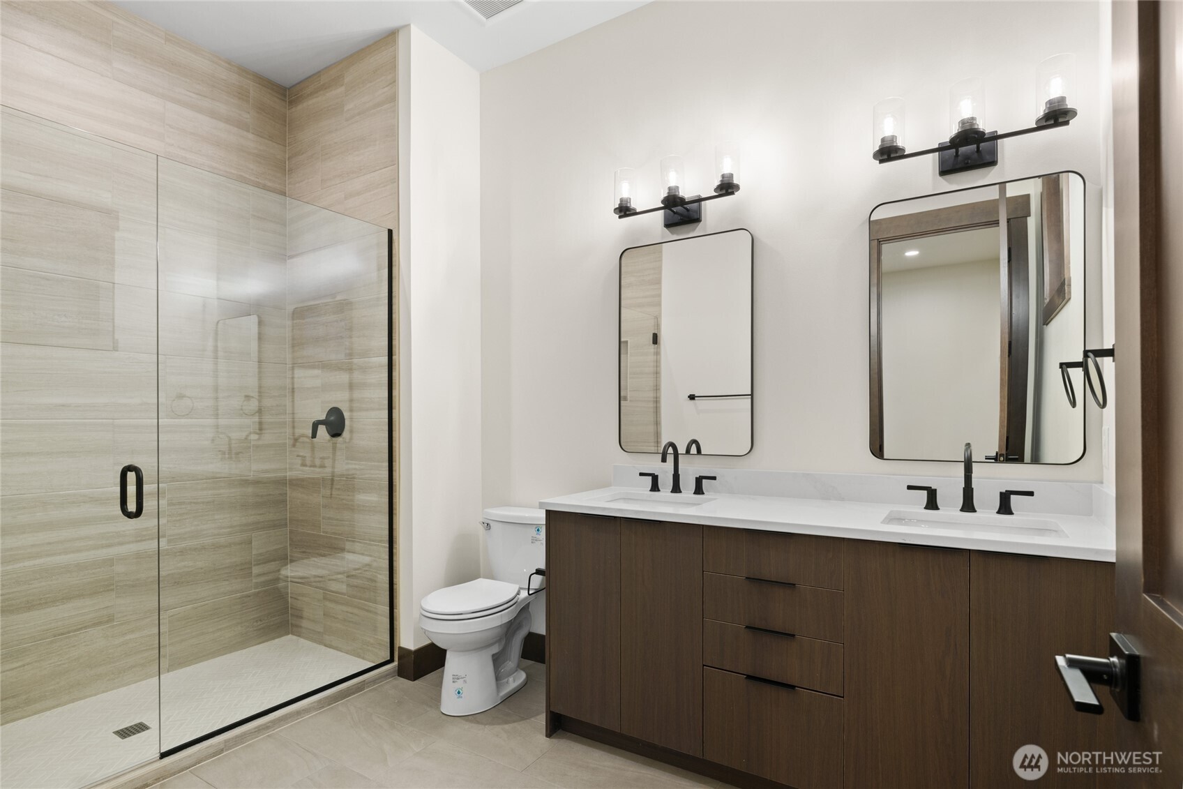21 Riverbend Loop Cle Elum, WA 98922 - Photo 14 of 21 a bathroom with double vanity sinks a toilet a glass door a shower and a mirror
