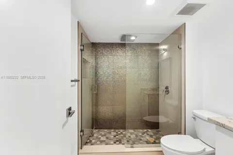 a bathroom with a toilet and shower