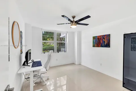 a view of a livingroom with wooden floor and a large window