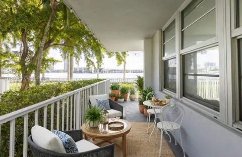 a view of a balcony with chairs and a table