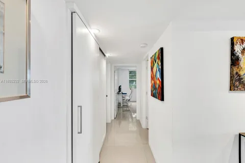 a view of a hallway with paintings on the wall