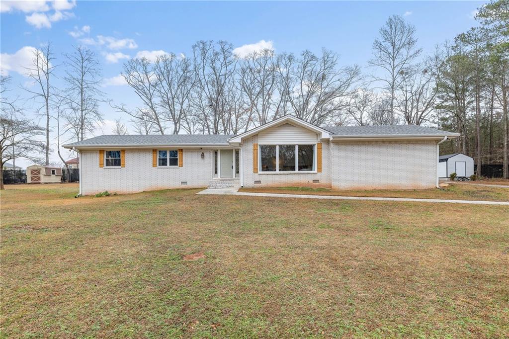 2859 Hammond Road Southwest Stockbridge, GA 30281 - Photo 1 of 1 a front view of a house with garden