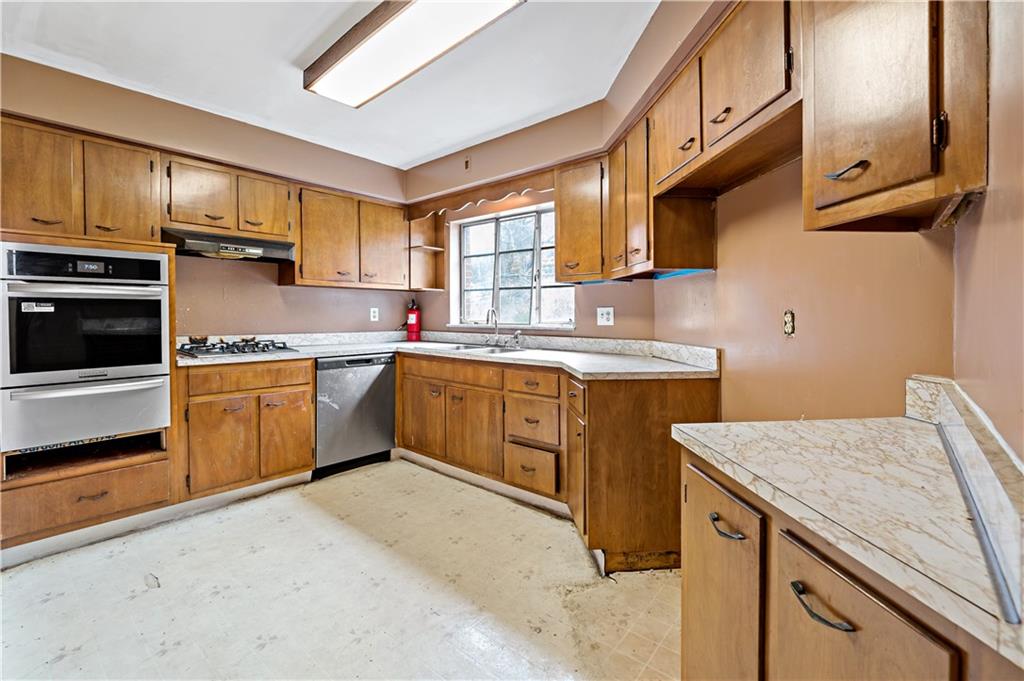 545 Stokes Avenue Braddock, PA 15104 - Photo 11 of 34 a kitchen with a stove sink and cabinets