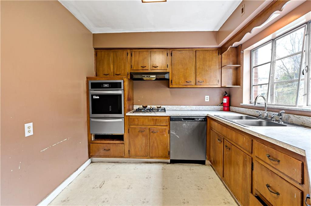 545 Stokes Avenue Braddock, PA 15104 - Photo 13 of 34 a kitchen with a sink stove and cabinets