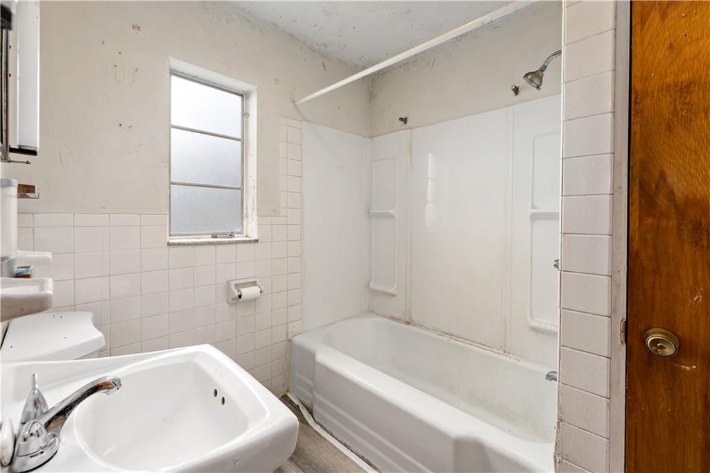 545 Stokes Avenue Braddock, PA 15104 - Photo 14 of 34 a white bath tub sitting next to a white toilet and sink