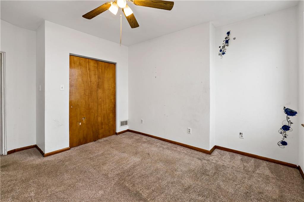 545 Stokes Avenue Braddock, PA 15104 - Photo 21 of 34 an empty room with a ceiling fan and carpet